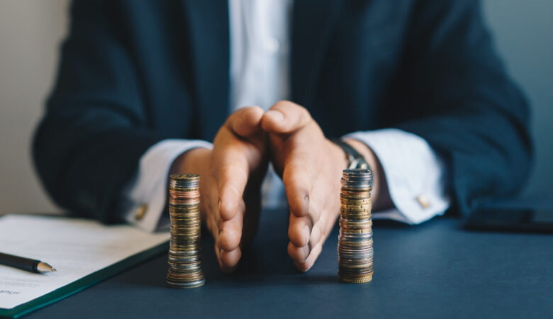 Concept of  saving and investing. Businessman separates stack co